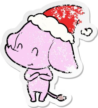 Sevimli el, insan tarafından çizilmiş Noel Baba şapkası giymiş bir fil çıkartması çizmiş.