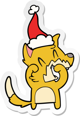 Gülen tilki eli bir insan tarafından çizilmiş Noel Baba şapkasının çıkartması.