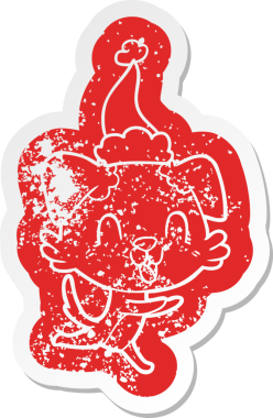 Gülen karikatür. Bir insan tarafından çizilmiş Noel Baba şapkası takan bir köpeğin çıkartması.