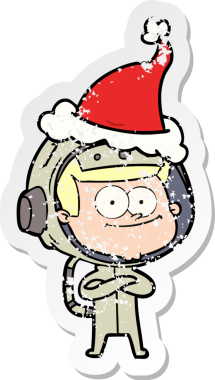 Mutlu astronot eli, bir insan tarafından çizilmiş Noel Baba şapkası giymenin sıkıntılı çıkartmasını çizdi.