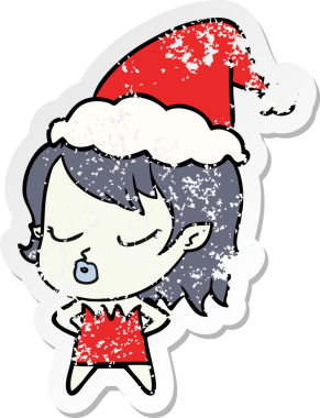 Sevimli bir el, insan tarafından çizilmiş Noel Baba şapkası takan vampir bir kızın üzgün çıkartması çizilmiş.