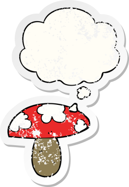 Düşünce baloncuğu olan karikatür mantarı insan tarafından çizilmiş yıpranmış bir çıkartma.
