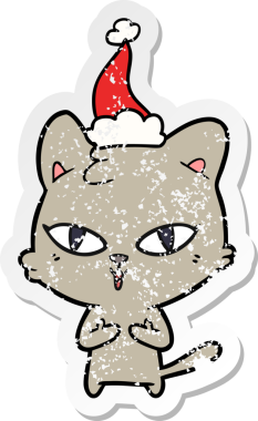 Bir insan tarafından çizilmiş Noel Baba şapkası takan bir kedinin çizilmiş el yazısı.