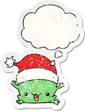 Düşünce baloncuğu olan şirin bir Noel kurbağası. Bir insan tarafından çizilmiş yıpranmış bir çıkartma.