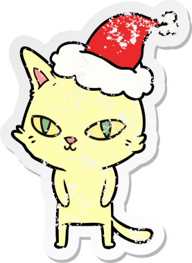 Bir insanın çizdiği Noel Baba şapkası takan parlak gözlü bir kedinin kederli çıkartması.