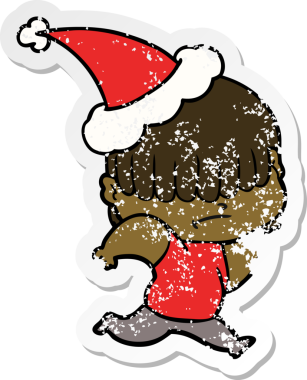 Bir insan tarafından çizilmiş, dağınık saçlı, Noel Baba şapkası takan bir çocuk.