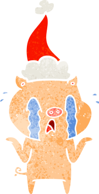 Ağlayan domuz eli bir insan tarafından çizilmiş Noel Baba şapkası çizilmiş.