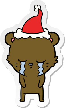 Ağlayan el çizimi bir insan tarafından çizilmiş Noel Baba şapkası takan bir ayı.