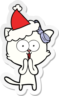 Bir insan tarafından çizilmiş Noel Baba şapkası takan bir kedinin el yazısı.