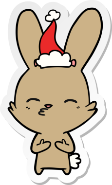 Bir insan tarafından çizilmiş Noel Baba şapkası giymiş garip bir tavşan eli çıkartması.