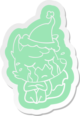 Ağlayan tilki çizgi film çıkartması. Bir insan tarafından çizilmiş Noel Baba şapkası.