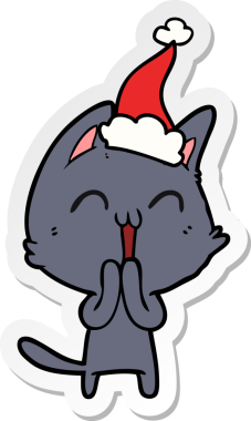 Bir insan tarafından çizilmiş Noel Baba şapkası takan bir kedinin çizilmiş mutlu el yazısı.