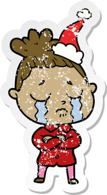 Bir insan tarafından çizilmiş, ağlayan, Noel Baba şapkası takan bir kadın.