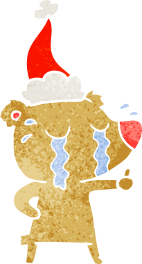 Bir insan tarafından çizilmiş Noel Baba şapkası giymiş ağlayan bir ayının el çizimi karikatürü