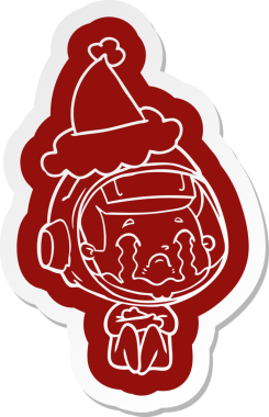 Bir insan tarafından çizilmiş Noel Baba şapkası giyen ağlayan bir astronotun garip karikatür çıkartması.