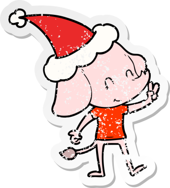 Sevimli el, insan tarafından çizilmiş Noel Baba şapkası giymiş bir fil çıkartması çizmiş.