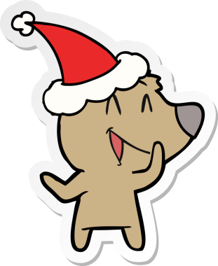 Gülen ayı eli bir insan tarafından çizilmiş Noel Baba şapkasının çıkartması.