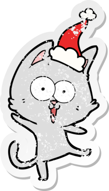 Komik bir el, bir insan tarafından çizilmiş Noel Baba şapkası takan bir kedi çıkartması çizmiş.