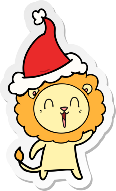 Gülen aslan eli bir insan tarafından çizilmiş Noel Baba şapkasının çıkartması.