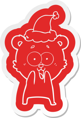 Heyecanlı oyuncak ayı acayip karikatür çıkartması. Bir insan tarafından çizilmiş Noel Baba şapkası.