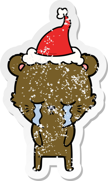 Ağlayan el, bir insan tarafından çizilmiş Noel Baba şapkası takan ayı çıkartması çizmiş.