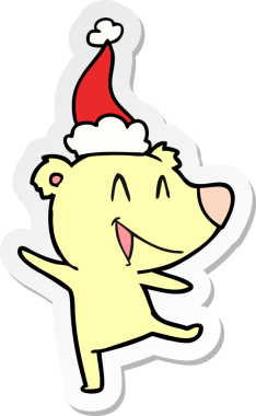 Gülen ayı eli bir insan tarafından çizilmiş Noel Baba şapkasının çıkartması.