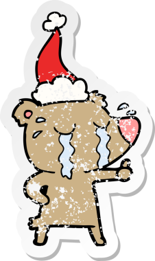 Bir insan tarafından çizilmiş Noel Baba şapkası giymiş ağlayan bir ayının el çizimi.