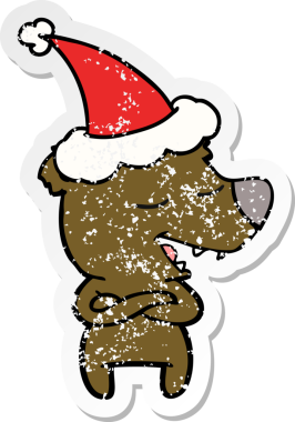 Bir insan tarafından çizilmiş Noel Baba şapkası takan bir ayının çizilmiş el yazısı.