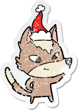 Dost canlısı el, bir insan tarafından çizilmiş Noel Baba şapkası takan bir kurt çıkartması çizmiş.