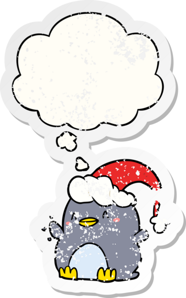 cartoon penguin wearing christmas hat with thought bubble as a distressed worn sticker drawn by a human