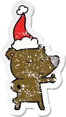 Mutlu el çizilmiş hüzünlü bir ayı çıkartması. Noel Baba şapkası takan bir ayı.