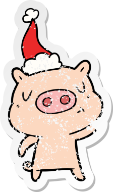 Bir insan tarafından çizilmiş Noel Baba şapkası giymiş içerik bir domuzun el çizimi çıkartması.