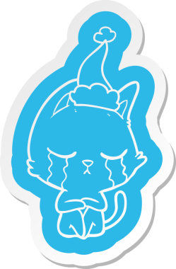 Bir insan tarafından çizilmiş Noel Baba şapkası giyen bir kedinin garip çizgi film çıkartması.