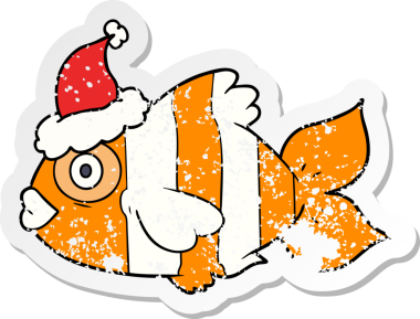 Bir insan tarafından çizilmiş Noel Baba şapkası giymiş egzotik bir balığın el yazısı.