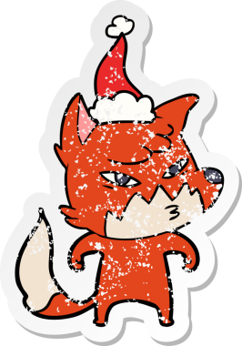 Bir insan tarafından çizilmiş Noel Baba şapkası giymiş bir tilki çizilmiş.