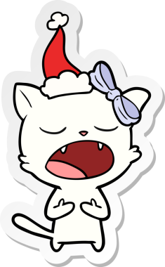 Bir insan tarafından çizilmiş Noel Baba şapkası giymiş bir kedi miyavlıyor.