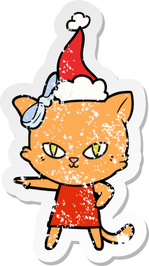 Sevimli el çizilmiş kedinin insan tarafından çizilmiş Noel Baba şapkası giydiği çıkartma.