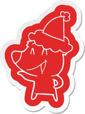 Gülen ayı çizgi film çıkartması. Bir insan tarafından çizilmiş Noel Baba şapkası.