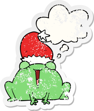 Düşünce baloncuğu olan şirin bir Noel kurbağası. Bir insan tarafından çizilmiş yıpranmış bir çıkartma.