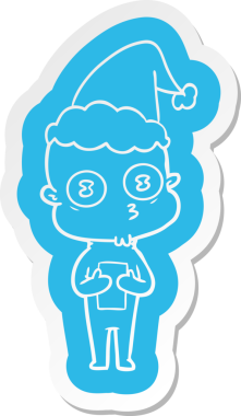 Bir insan tarafından çizilmiş Noel Baba şapkası giyen tuhaf kel bir uzaylının çizgi film çıkartması.