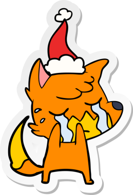 Ağlayan tilki eli bir insan tarafından çizilmiş Noel Baba şapkasının çıkartması.