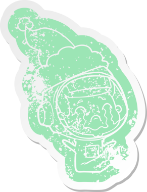 Bir insan tarafından çizilmiş Noel Baba şapkası giyen ağlayan bir astronotun garip karikatürü.