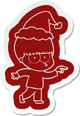 Bir insan tarafından çizilmiş Noel Baba şapkası takan bir çocuğun garip çizgi film çıkartması.