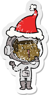 Gülen el, bir insan tarafından çizilmiş Noel Baba şapkası giymiş bir astronotun üzgün çıkartmasını çizdi.