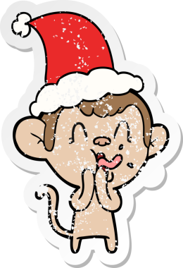 Çılgın el, insan tarafından çizilmiş Noel Baba şapkası takan bir maymunun sıkıntılı çıkartmasını çizdi.