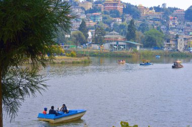 Lake City Landscape view with tree branches in the foreground. Mirik Lake Darjeeling West Bengal India South Asia Pacific