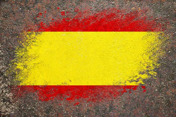 Flag of Spain. Flag is painted on a rusty surface. Rusty background. Creative background
