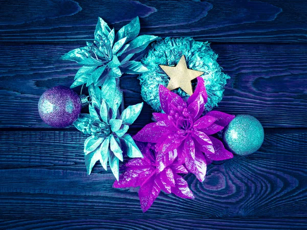 stock image Christmas decorations. Top view New Year decorations on a dark wooden background. Blue toning garlands, balls, stars and toys for Christmas decor. Festive postcard. Selective soft focus