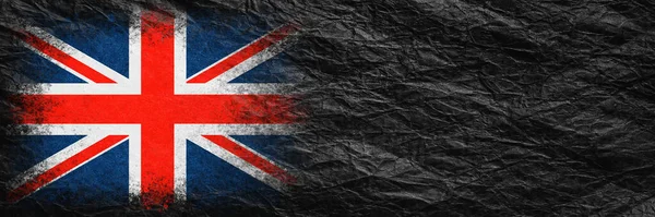 Flag of Britain. Flag is painted on black crumpled paper. Paper background. Copy space. Textured creative background