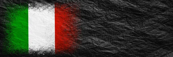 Flag of Italy. Flag is painted on black crumpled paper. Paper background. Copy space. Textured creative background